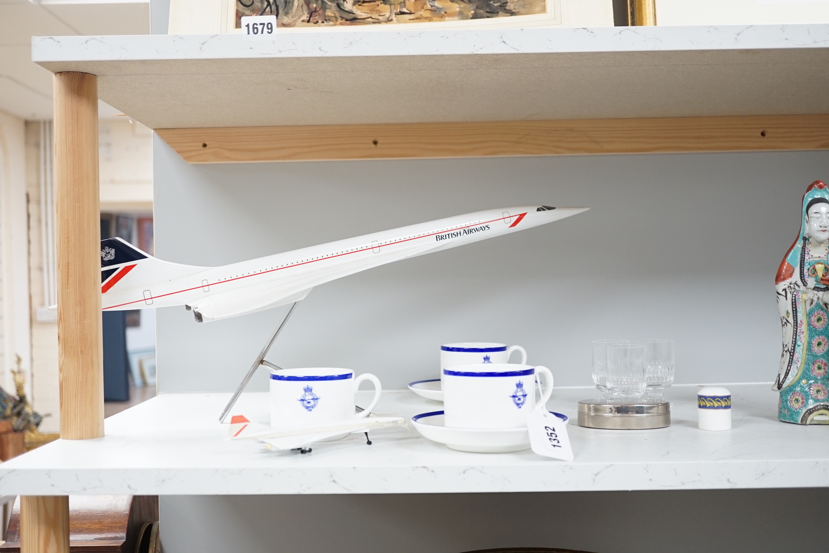 Concorde memorabilia comprising four British Airways glass tots, a pair of plated cased clothes brushes, three graduated scale models of Concorde and a bottle opener together with four Wedgwood Royal Air Force Club mugs